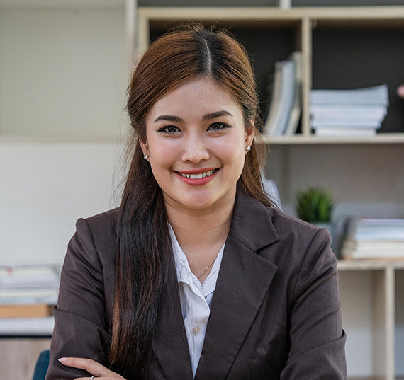 Attractive young lawyer in office Business woman and lawyers with brass scale on wooden desk in office. Law, legal services, advice, Justice and real estate concept